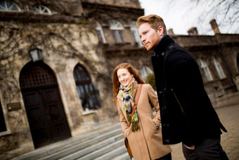 Man and woman outside an ivy-covered building