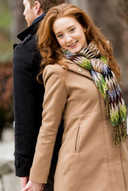 Smiling woman with red hair holding hands with man