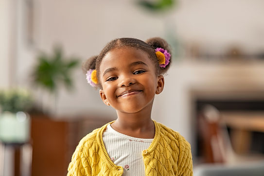 Smiling cute little african american girl with two pony tails looking at camera Portrait o