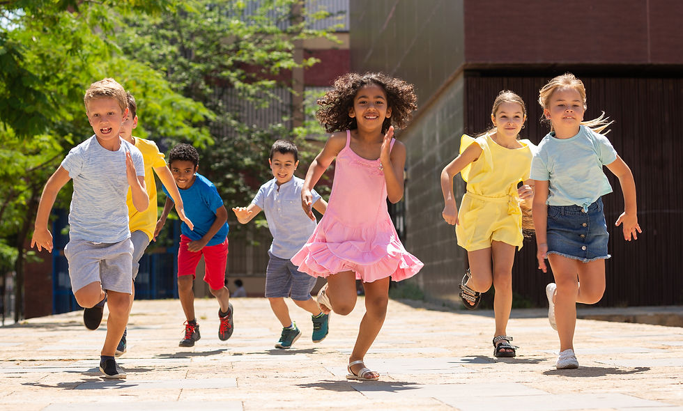 Team of positive kids running in race in the street and laughing outdoors .jpg