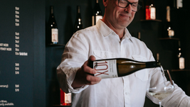 A man pouring wine into a glass