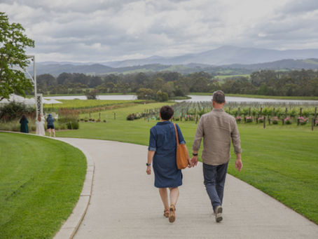 Couple walking down a path to a winery
