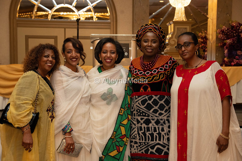 A moment of unity—women of the diaspora standing in tradition, recognition, and shared purpose.