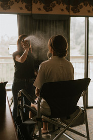 a bride getting her make up done before her wedding