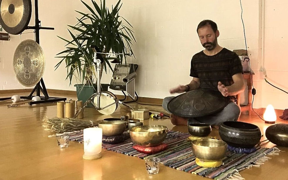 Playing hand pan at group soundbath