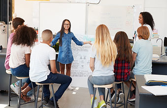 Schoolgirl presenting in front of scienc
