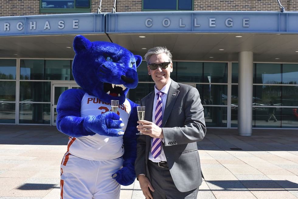 Perseus the Panther and President Michael Steiper holding sparkling cider while smiling for the camera. (Photo by Sophia Pallozzi)