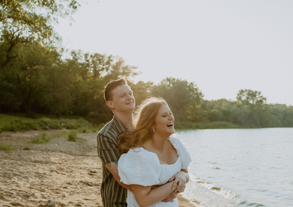 Couple hugging by the water, sunny day, Weddings, smiling at the sun.