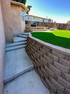 Robust retaining wall managing soil and adding landscape design.