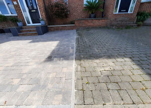 A cleaning stone patio next to an uncleaned on.