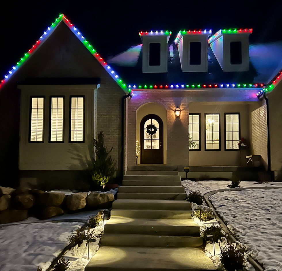Gabled home with Christmas lights and lighted door