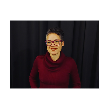 Smiling woman with glasses in a maroon turtleneck.