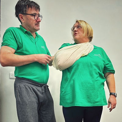 Donald and Kate demonstrating application of a high arm sling