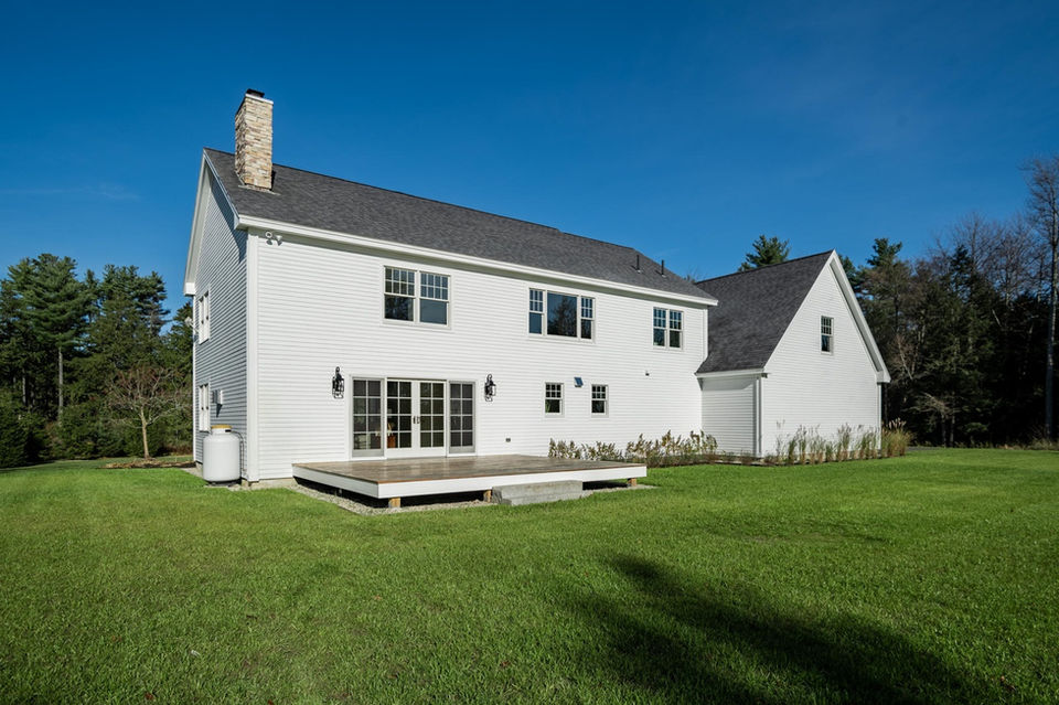 White rural home with backyard deck