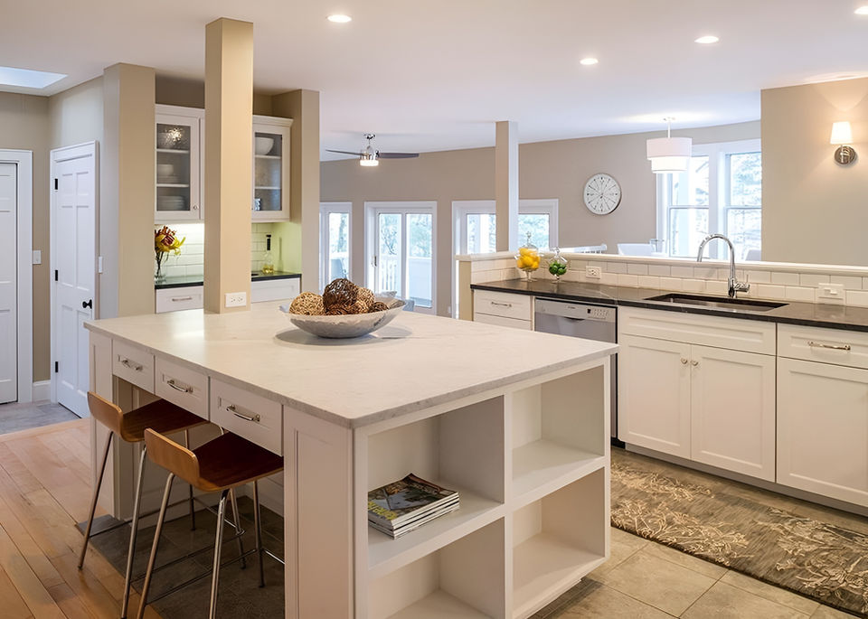 Modern kitchen with white island and open living space