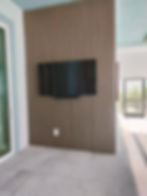 Wall-mounted TV on wood paneling for high end home remodeling ideas