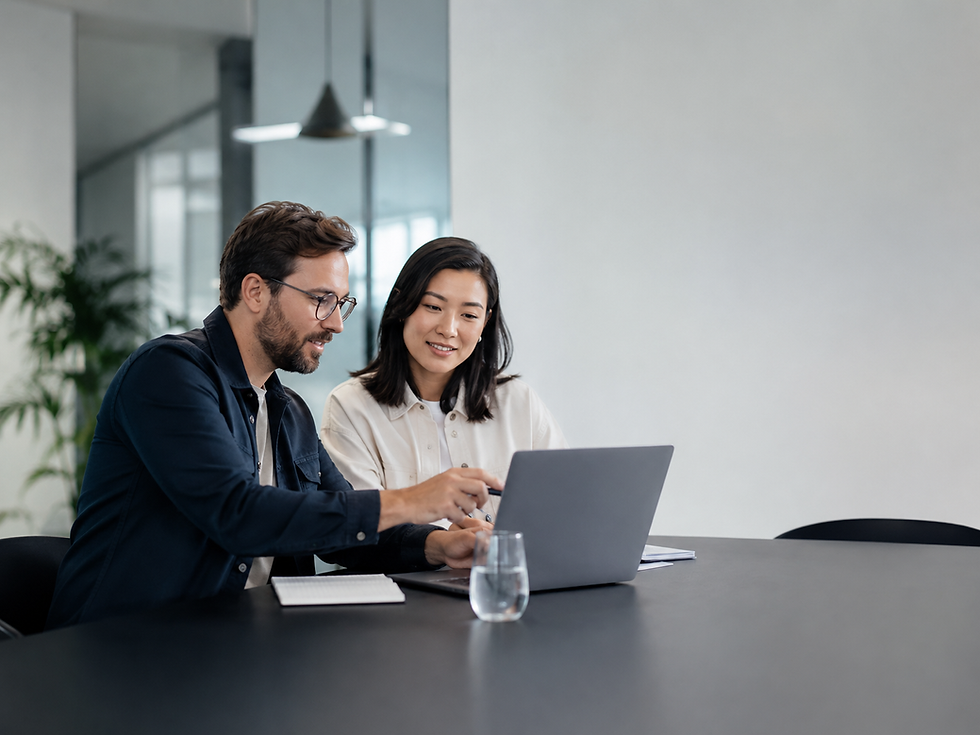 Two business professionals reviewing a laptop together