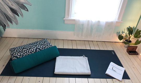 yoga teacher training notes on a yoga mat in a yoga studio