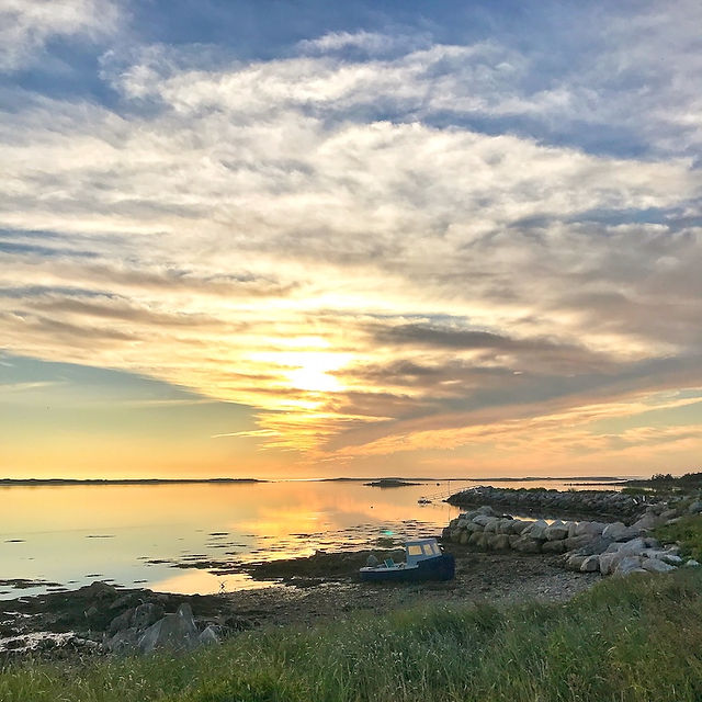 Small boat waterside at sunset on Cape Sable Island, Nova Scotia