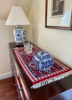 Bedroom dresser with coastal decor details at The East Wind Guesthouse