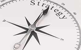 A compass pointing toward the North and the word Strategy 