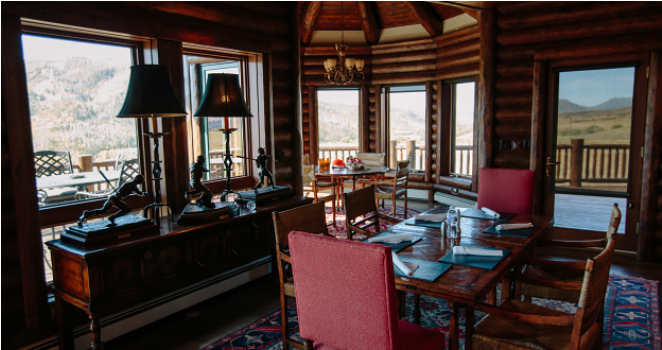 a room with a table and chairs and a lamp