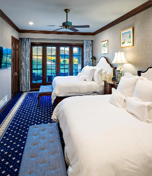 a hotel room with two beds and a ceiling fan
