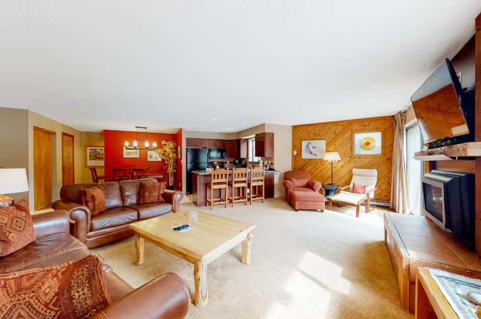 a living room with a couch and chairs and a table