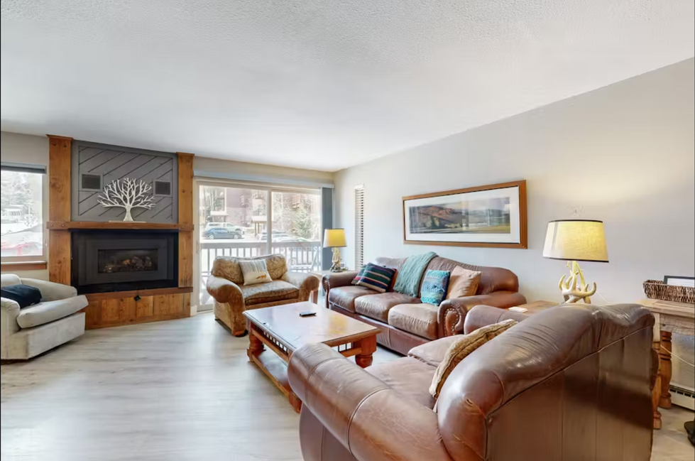 a living room filled with furniture and a fireplace