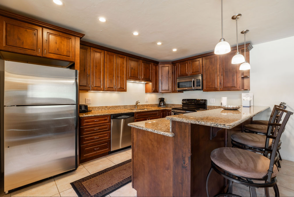 a kitchen with stainless steel appliances and wooden cabinets