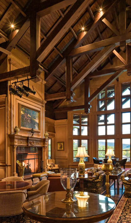 a living room with a fireplace and lots of windows