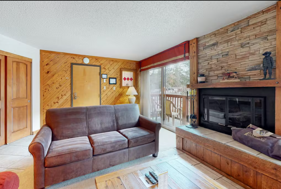 a living room with a couch and a fireplace