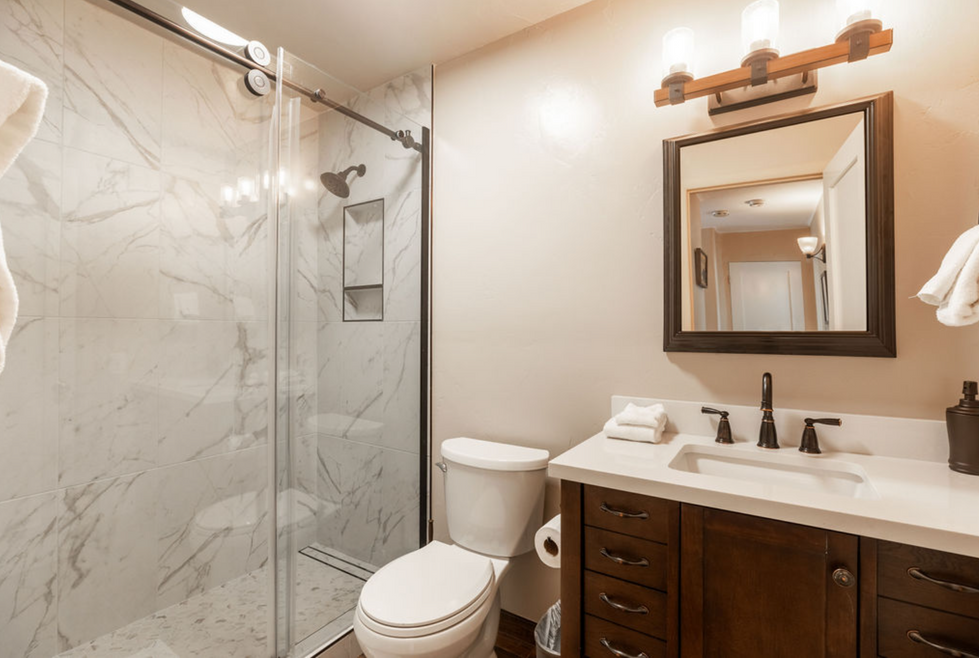 a bathroom with a toilet a sink and a shower
