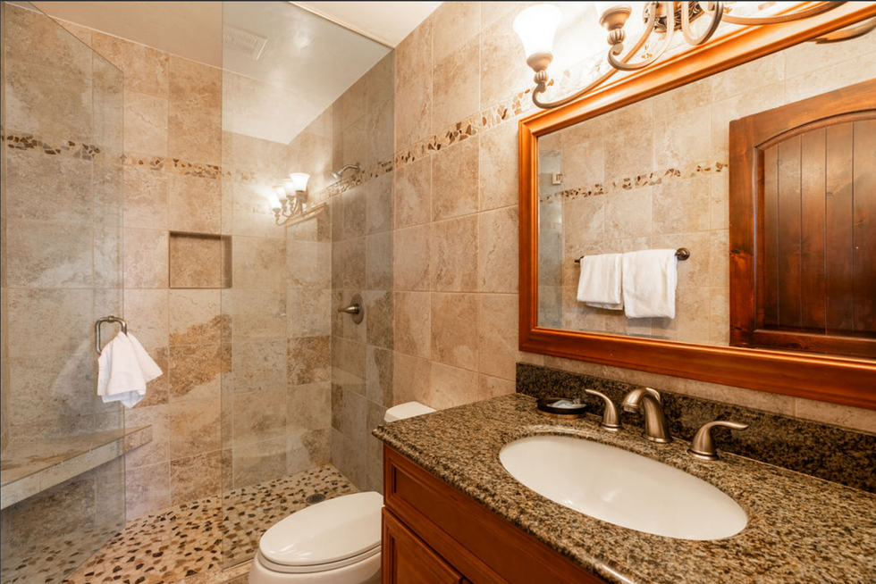 a bathroom with a toilet a sink and a mirror