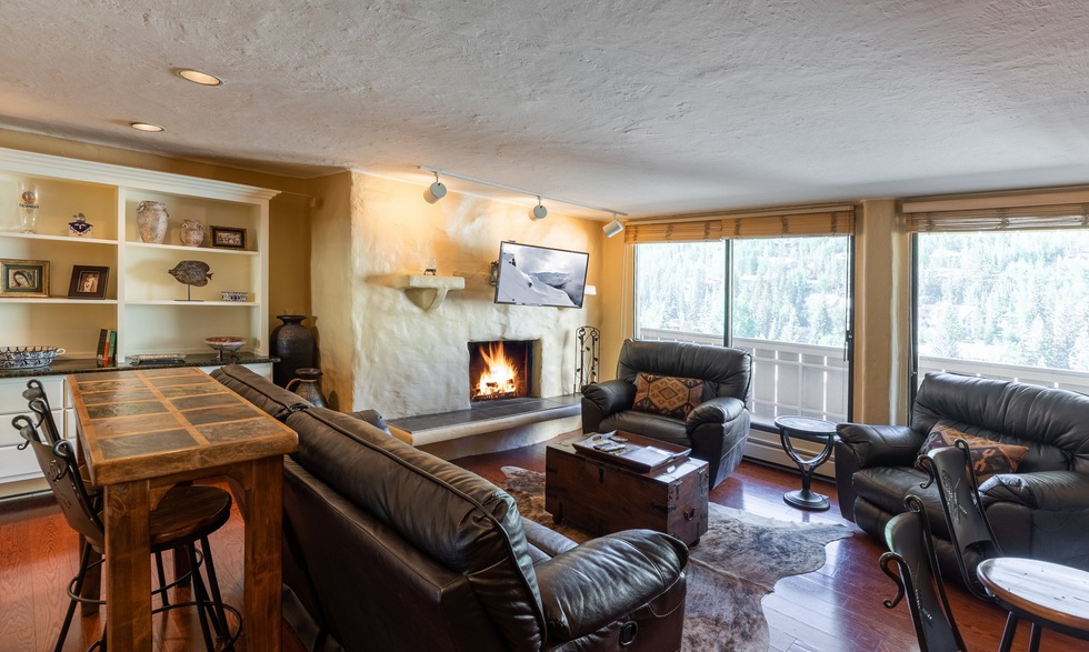 a living room with a fireplace and a flat screen tv