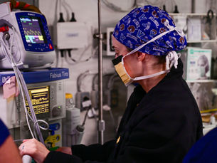 Anaesthetic nurse preparing a patient for surgery in an operating theatre