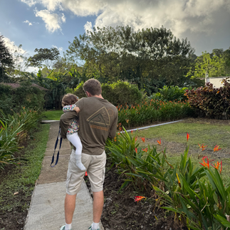 Man holding baby and flowers