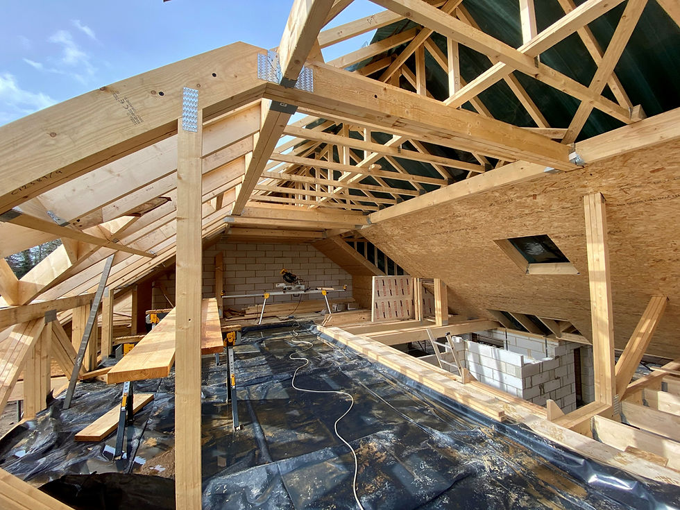 Wooden roof structure under construction with visible structural fixings for a new building.