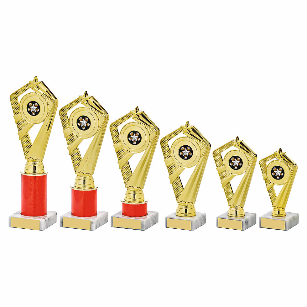 Trophies lined up on a workbench with a precision machine and tools used for engraving.