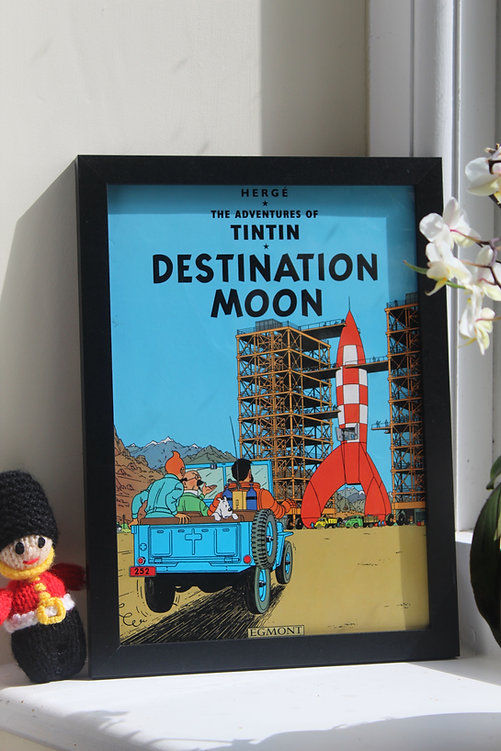 Thumbnail: Tintin Destination Moon book framed, rocket launch in cartoon style, window background.