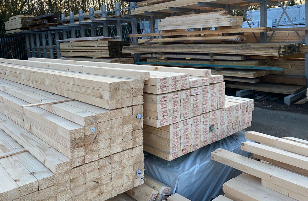 Stacks of new lumber and timber planks stored in a building yard.
