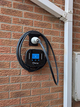 EV charging point on brick wall