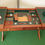 Thumbnail: Wooden desk with open compartments, tools, accessories, and green leather padding.