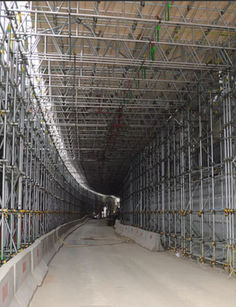 Workers inside tunnel, scaffolding, construction