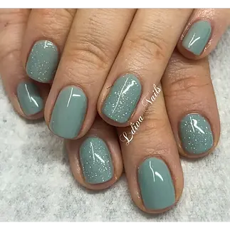 Teal nails with glitter finger