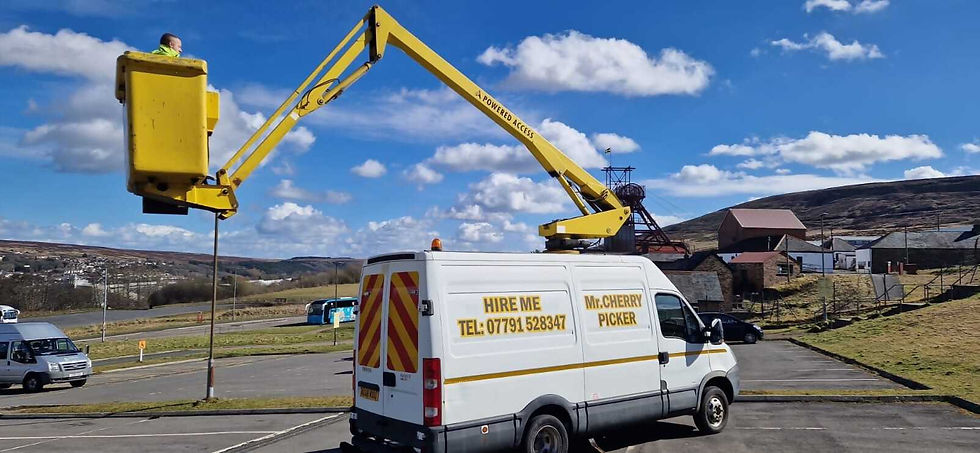 Mr Cherry Picker Hire van parked up with man in bucket