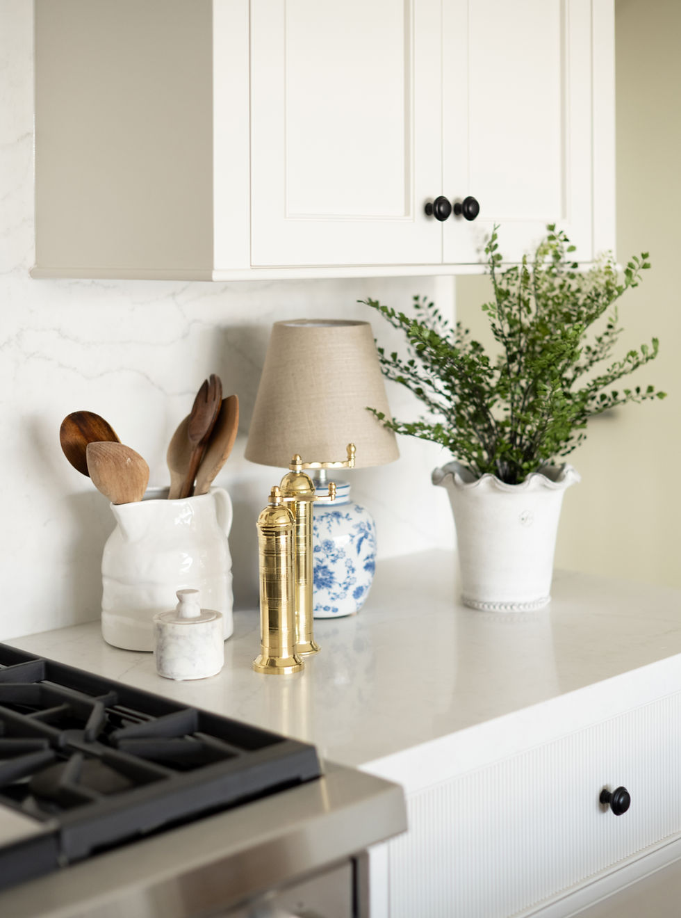 Thumbnail: Stoneware pitcher styled on countertop with wooden spoons placed inside.