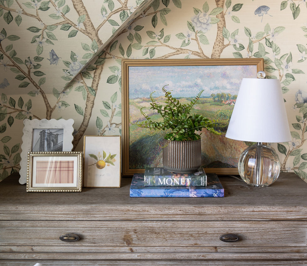 Thumbnail: Brass and glass frame styled on dresser with other picture frames and plants.
