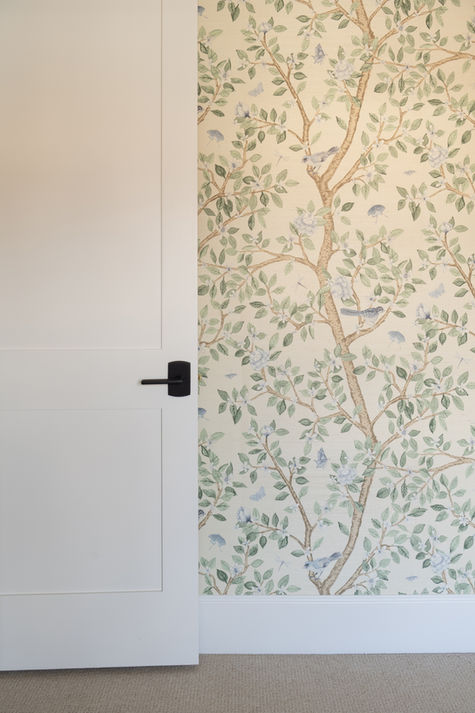 Close-up of floral pattern wallpaper next to a plain white wall.