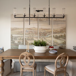 A timeless cottagecore dining space featuring a bespoke wooden table and heritage-inspired mural art.
